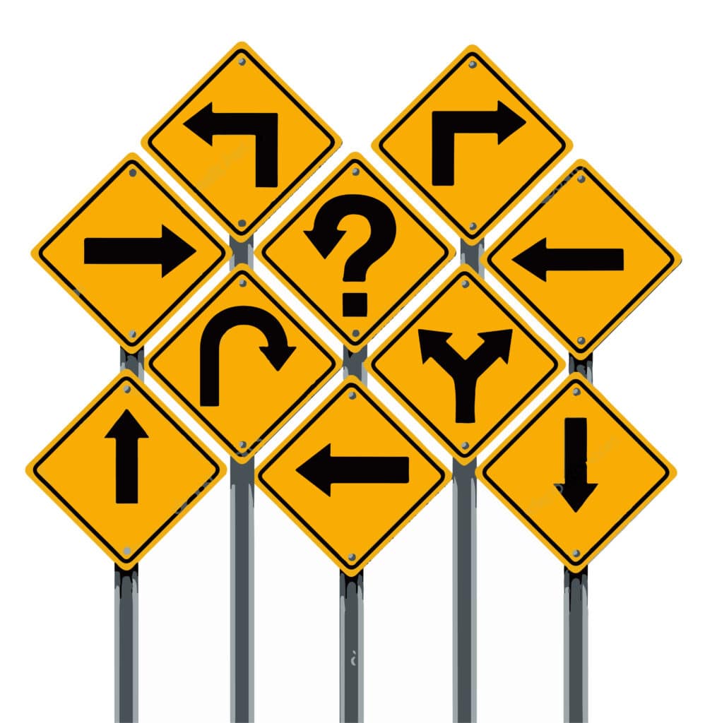 yellow road signs with black arrows pointing in all different directions